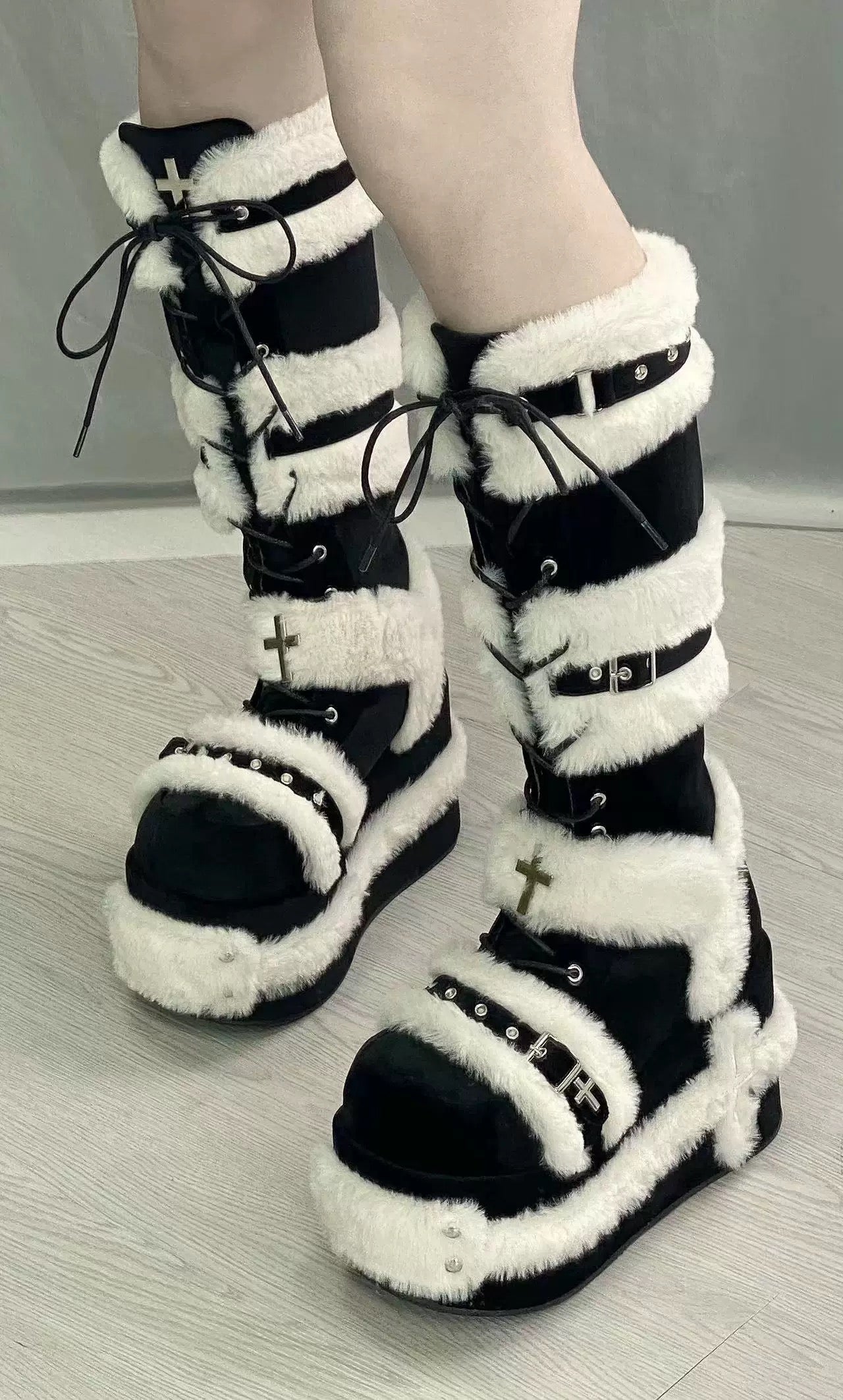 Black and white platform boots with crosses and faux fur, featuring a goth and punk style